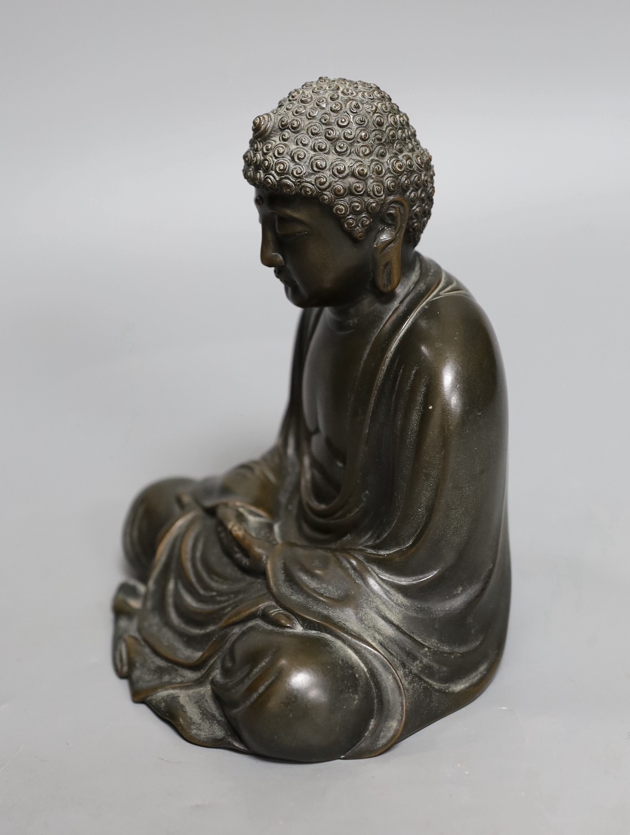 An early 20th century Japanese bronze figure of a seated Buddha, signed, 17cm